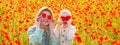 Mother and daughter on the poppies field background. Spring family banner. Poppies meadow with poppys flowers. Closing Royalty Free Stock Photo