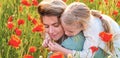 Mother and daughter on the poppies field background. Spring family banner. Portrait of mother and daughter walking Royalty Free Stock Photo