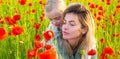 Mother and daughter on the poppies field background. Spring family banner. Woman with child girl in field with red Royalty Free Stock Photo