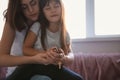 Mother with daughter praying at home Royalty Free Stock Photo