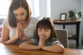 Mother with daughter praying at home Royalty Free Stock Photo