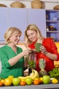 Mother and daughter preparing fruit for making fresh juice