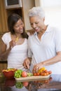 Mother And Daughter Preparing A Meal