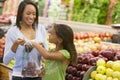 Mother and daughter in produce section Royalty Free Stock Photo