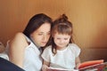 Mother and daughter reading a book