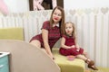 Mother and daughter in red dresses