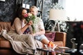 Mother and daughter relationship concept. A teenage girl congratulates happy woman on her birthday and gives her flowers