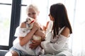 Mother and daughter relationship concept. A woman congratulates happy teenage girl on her birthday and gives her a dog