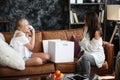 Mother and daughter relationship concept. A woman congratulates happy teenage girl on her birthday and gives her a gift Royalty Free Stock Photo