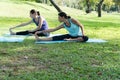 Mother and daughter Relax by doing exercise practicing yoga in the park. Healthy lifestyle concept Royalty Free Stock Photo