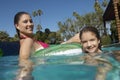 Mother And Daughter Relaxing On Inflatable Raft In Swimming Pool Royalty Free Stock Photo