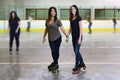 Mother and daughter at roller skating rink focus on mom