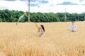 Mother and daughter run in a wheat field with a kite in the summer. Well-planned and active weekend. Happy childhood. Royalty Free Stock Photo