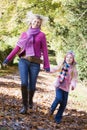 Mother and daughter running along path Royalty Free Stock Photo