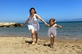 Mother and daughter running on beach Royalty Free Stock Photo