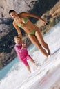 Mother and daughter running at the beach Royalty Free Stock Photo