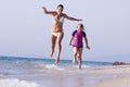 Mother and daughter running at the beach Royalty Free Stock Photo