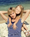 Mother with daughter at sea cost together, happy real family Royalty Free Stock Photo