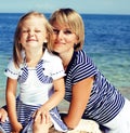 mother with daughter at sea cost together, happy real family smi Royalty Free Stock Photo