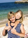 mother with daughter at sea cost together, happy real family smi Royalty Free Stock Photo