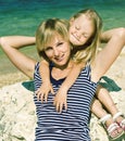 mother with daughter at sea cost together, happy real family smi Royalty Free Stock Photo