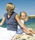 Mother with daughter at sea cost together, happy real family smiling looking to horizont, lifestyle people concept, on Royalty Free Stock Photo