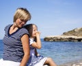 Mother with daughter at sea cost together, happy real family smiling looking to horizont, lifestyle people concept, on Royalty Free Stock Photo