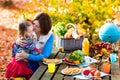 Mother and daughter set table for picnic in autumn Royalty Free Stock Photo