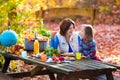 Mother and daughter set table for picnic in autumn Royalty Free Stock Photo