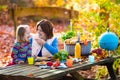 Mother and daughter set table for picnic in autumn Royalty Free Stock Photo