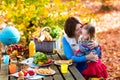 Mother and daughter set table for picnic in autumn Royalty Free Stock Photo