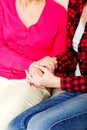 Mother and daughter sitting on couch and holding hands Royalty Free Stock Photo