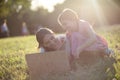 Mother and daughter sitting on grass and using laptop Royalty Free Stock Photo