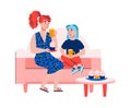 Mother and daughter sitting on sofa drinking tea with dessert.