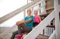 Mother and daughter sitting and talking on beach-house steps Royalty Free Stock Photo