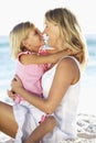 Mother And Daughter Sitting Together On Beach Royalty Free Stock Photo