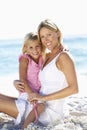 Mother And Daughter Sitting Together On Beach Royalty Free Stock Photo