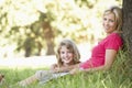 Mother And Daughter Sketching In Countryside Leaning Against Tree Royalty Free Stock Photo