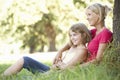 Mother And Daughter Sketching In Countryside Leaning Against Tree Royalty Free Stock Photo