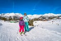 Mother and daughter with ski resort, snow capped mountains and forest in background, Andorra Royalty Free Stock Photo