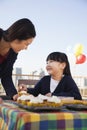 Mother and daughter smiling and decorating cupcakes Royalty Free Stock Photo