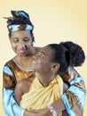 Mother and daughter smiling and hugging each other, family love, isolated, light orange background