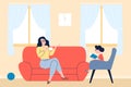 Mother and daughter spend time together. Little girl reading book, woman drinks coffee or tea at sofa. Family day, rest Royalty Free Stock Photo