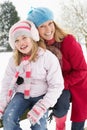 Mother And Daughter Standing Outside In Snow