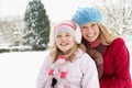 Mother And Daughter Standing Outside In Snowy Land