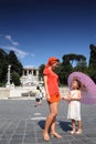 Mother and daughter standing on Piazza Popolo