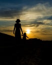 Mother and daughter strolling at sunset. beautiful landscape