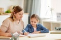 Mother and Daughter Studying at Home