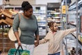 Mother and daughter in supermarket grocery shopping together Royalty Free Stock Photo