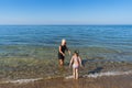 A mother and daughter swim on a beach in Estonia